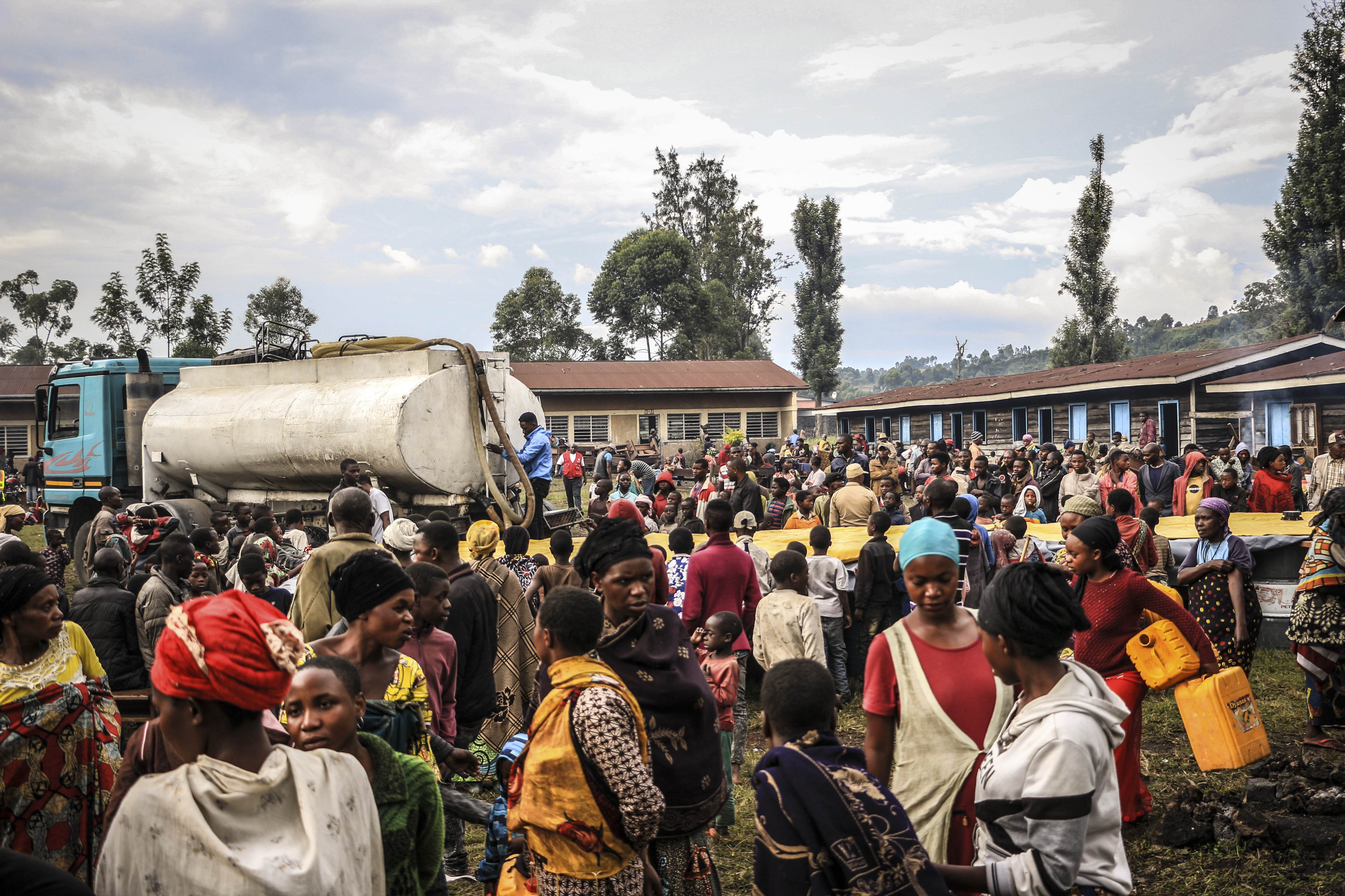 This scene takes place in Kanyaruchinya, in the province of North Kivu, in the DRC, in 2022, where the ICRC has installed a drinking water reservoir for refugees. In 2023, 36,086,869 civilians (residents, IDPs, returnees, and refugees) had access to drinking water, shelter, or better living conditions